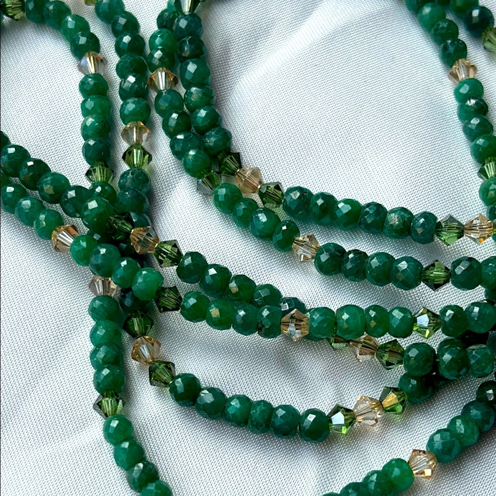 Green emerald-colored necklace with accent beads.